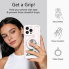 Woman taking a selfie while holding an iPhone by the Pretty in PinkMas grip ring; easy selfies, more comfort and video stand