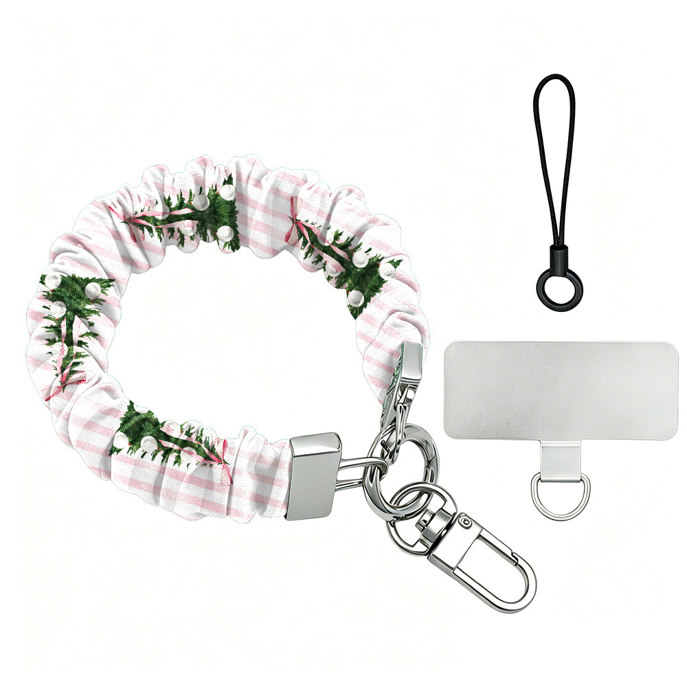 Pretty in PinkMas scrunchie phone wrist strap laid flat with silver clasp and phone tab, pink and white stripes with little bow-tied Christmas trees