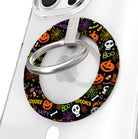 Spooky Hold It Fancy MagSafe grip ring shown on a clear iPhone case, black ring covered in orange pumpkins, white skulls and spiderwebs.
