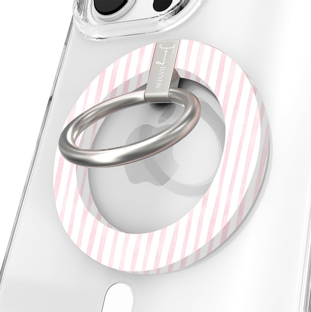 Close-up of the Pretty in PinkMas MagSafe grip ring in pink and white candy stripes with a brushed silver ring on a clear iPhone case