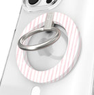 Close-up of the Pretty in PinkMas MagSafe grip ring in pink and white candy stripes with a brushed silver ring on a clear iPhone case