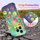 Wavy iPhone case featuring vibrant watercolor flowers in pink, red, yellow, and orange on a green and blue gradient background.
