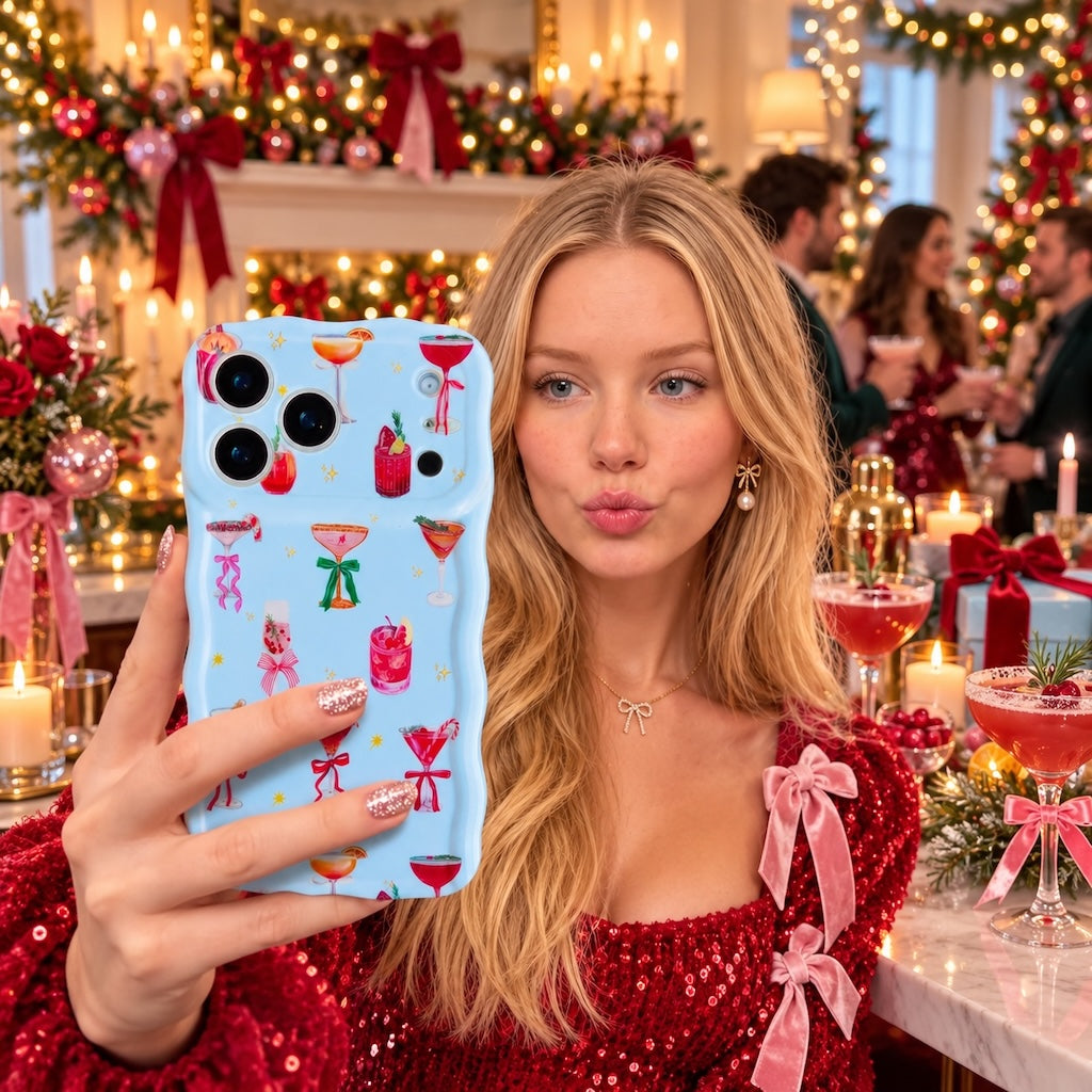 Woman in a red sequin top with pink bows taking a selfie with the Holiday Spirits, Please? iPhone case at a festive cocktail bar