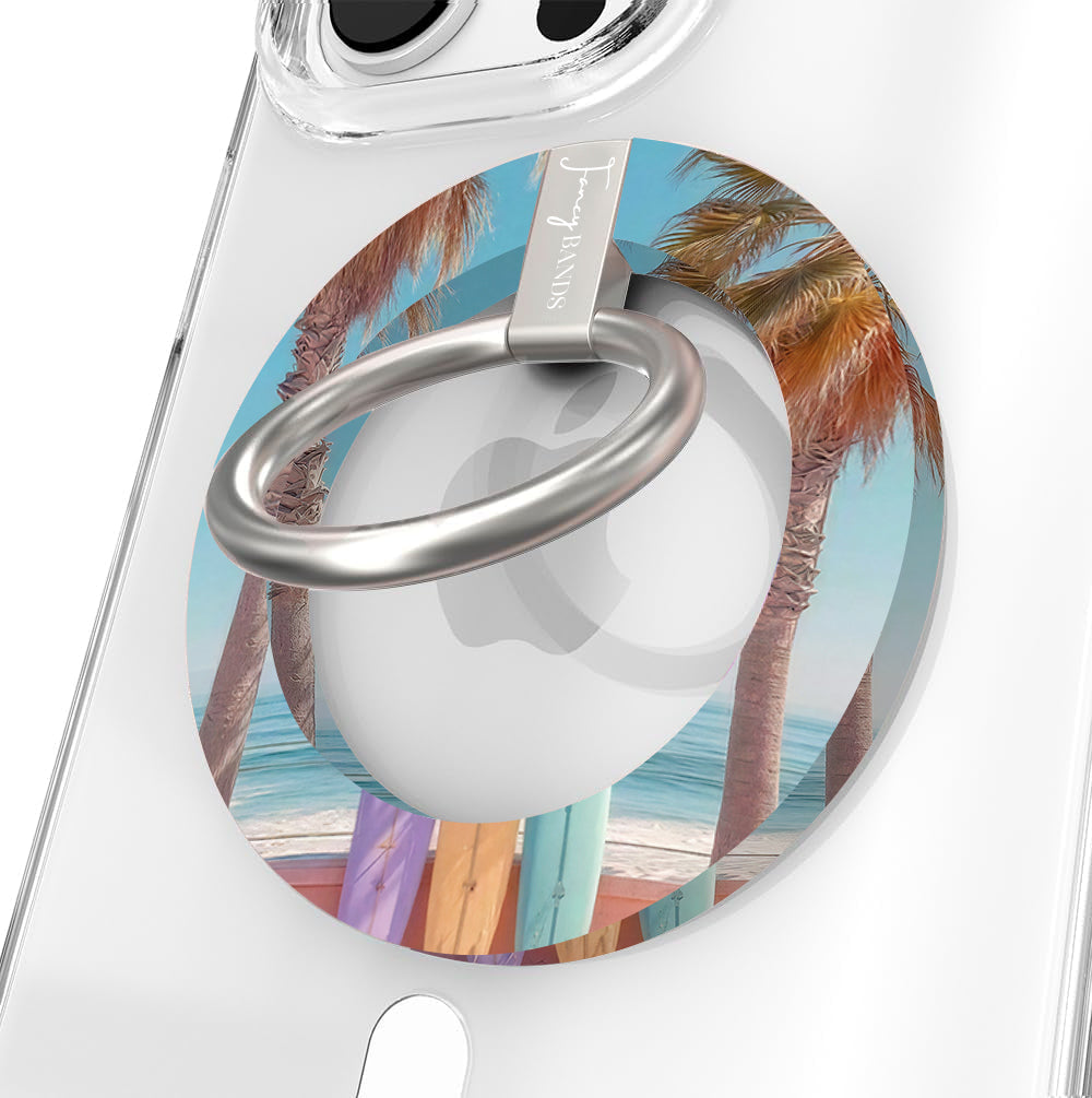 Sweet Summer MagSafe phone grip ring featuring surfboards leaning against palm trees on a tropical beach with ocean waves and a blue sky