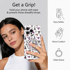 Get a Grip infographic for the Witch Please MagSafe grip ring, showing a model holding her witch hat print phone one-handed plus easy selfies, added comfort, and video stand uses.