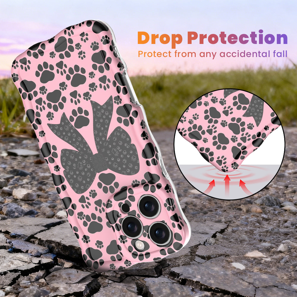 Trendy pink wavy iPhone case featuring a pattern of black paw prints and a large central black bow with tiny paw print details.
