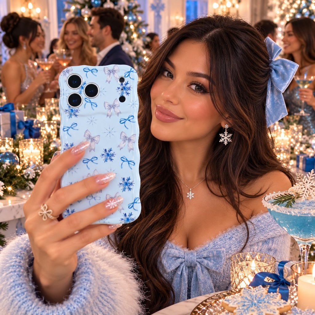Woman in a fluffy blue bow cardigan taking a selfie with the Snow Pretty In Blue iPhone case at a blue and silver holiday party