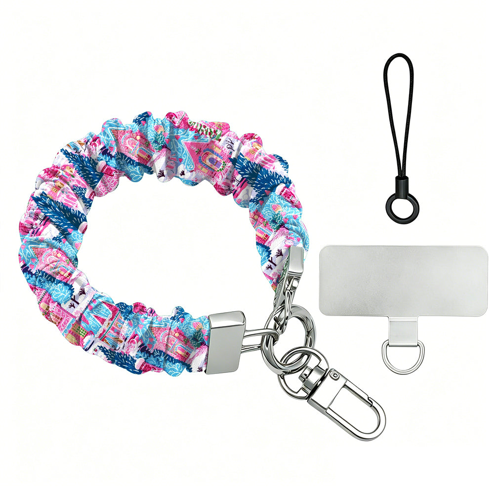 Sugarplum Square scrunchie phone wrist strap laid flat with silver clasp and phone tab, pink gingerbread houses and blue pines