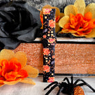 Single Haunted Blossoms Samsung Galaxy Watch band strap standing tall showing coral roses and spiderwebs over black silicone.