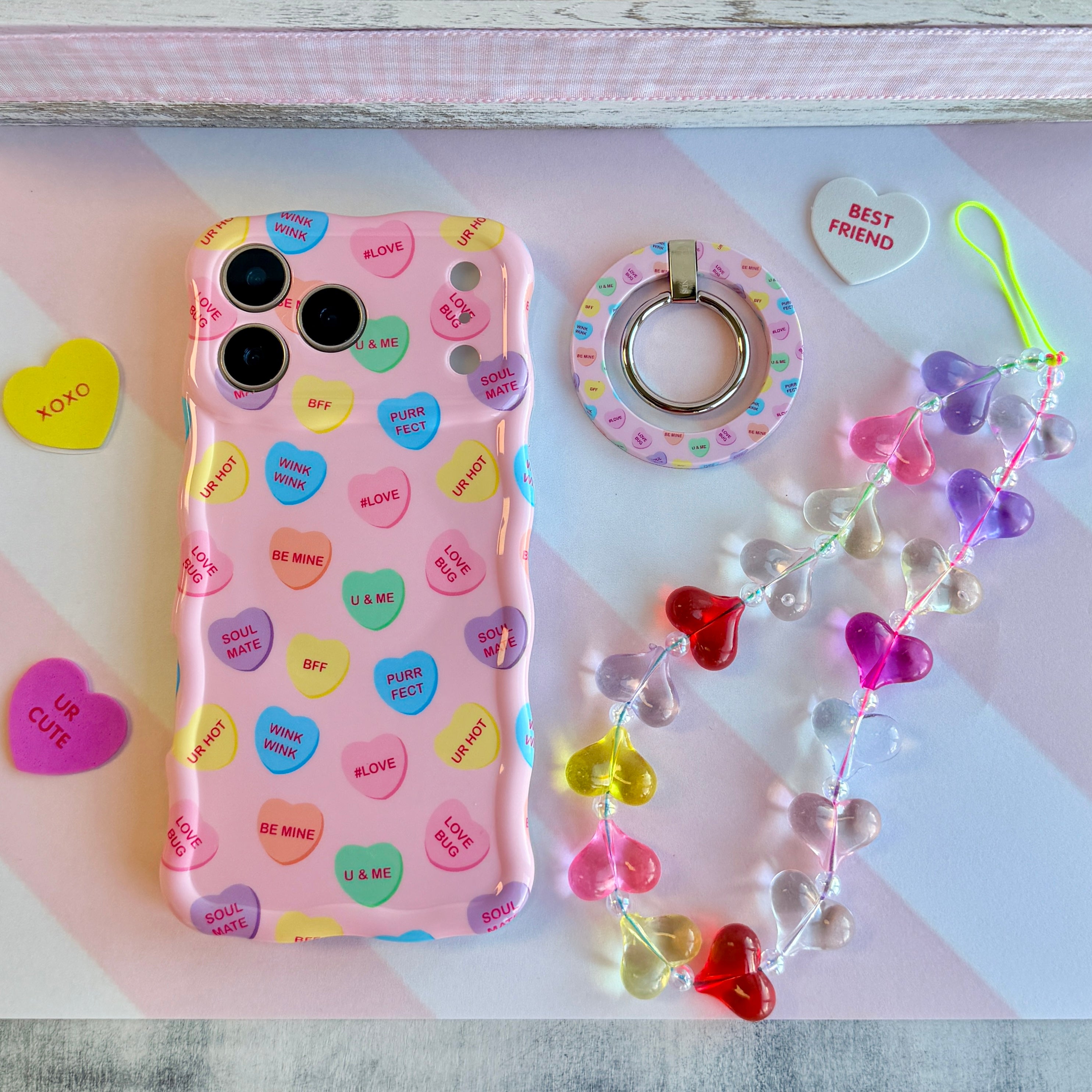 Candy hearts phone charm with translucent rainbow heart beads and crystal accents on conversation hearts phone case
