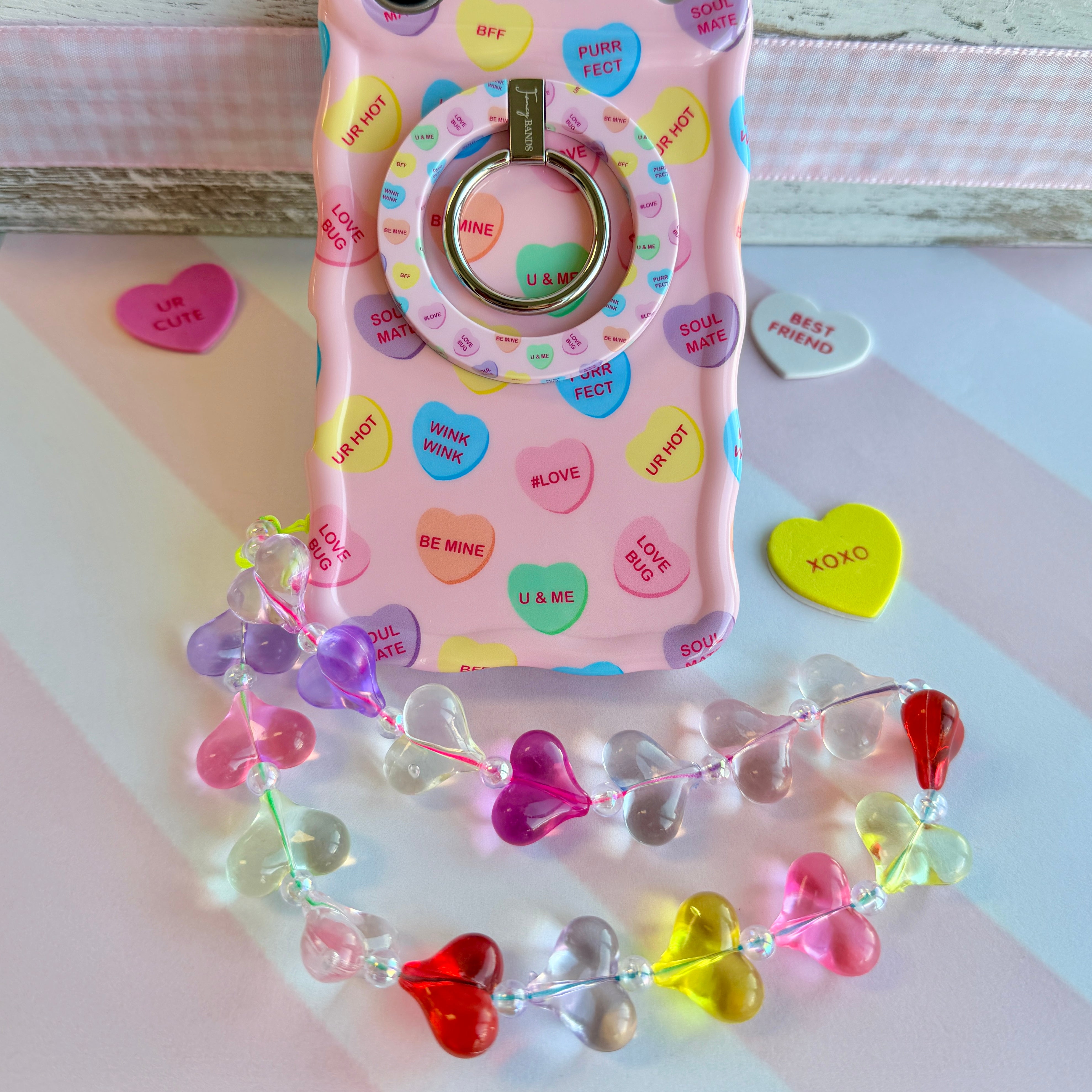 Candy hearts phone charm with translucent rainbow heart beads and crystal accents on conversation hearts phone case
