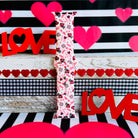 Tick-Tack-Love Apple Watch band with LOVE text, XOXO, and hearts in pink and red on white background with Valentine's decor
