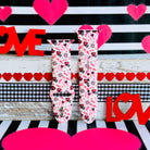 Tick-Tack-Love Apple Watch band with LOVE text, XOXO, and hearts in pink and red on white background with Valentine's decor
