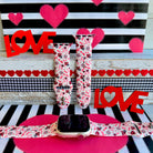 Tick-Tack-Love Apple Watch band with LOVE text, XOXO, and hearts in pink and red on white background with Valentine's decor
