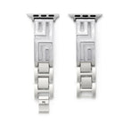 Axiom Link stainless steel Apple Watch band with Greek key cut-out pattern in brushed silver finish on a woman's wrist