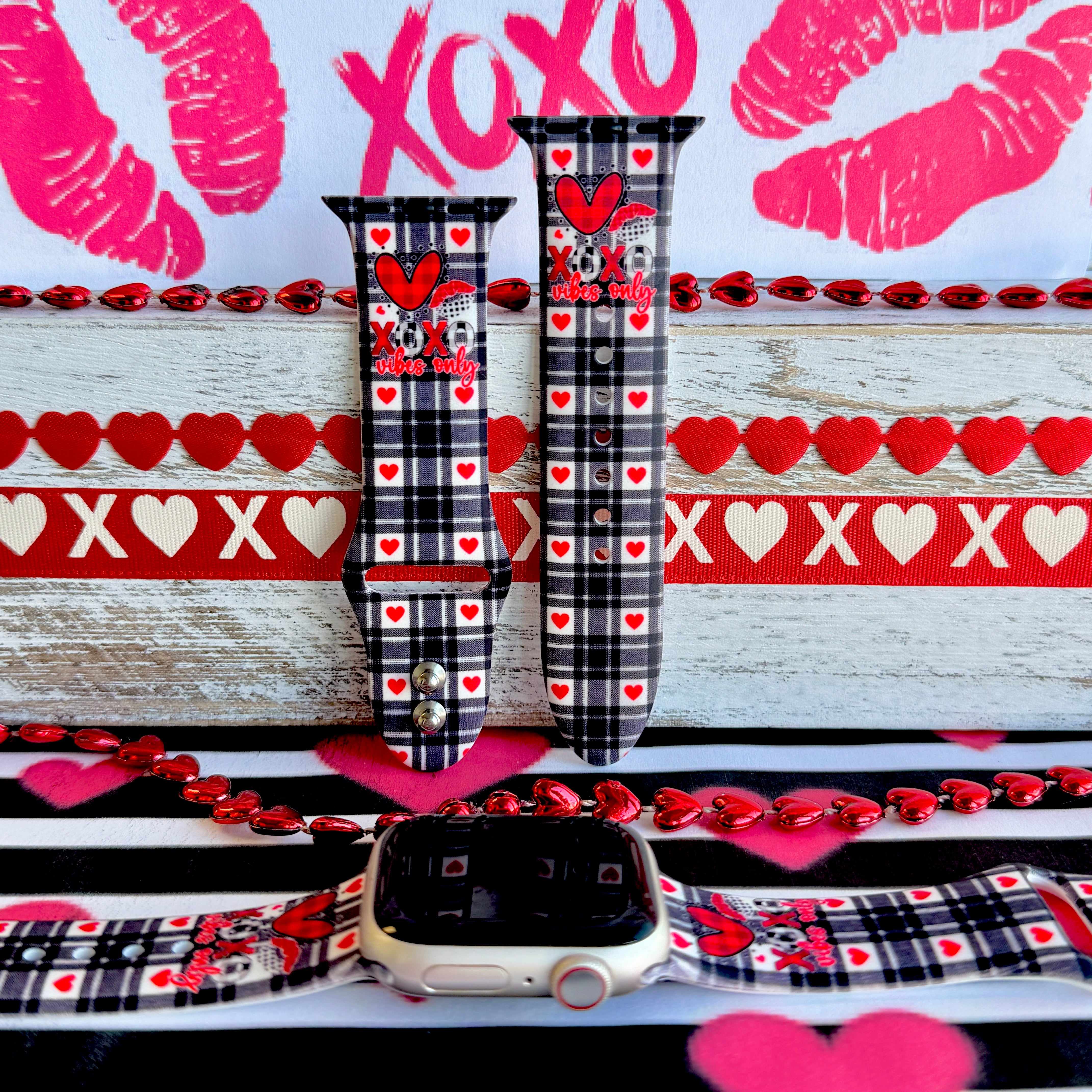 Plaid Crush Vibes Apple Watch band with black buffalo check, red hearts, and XOXO Vibes Only message with Valentine's decorations
