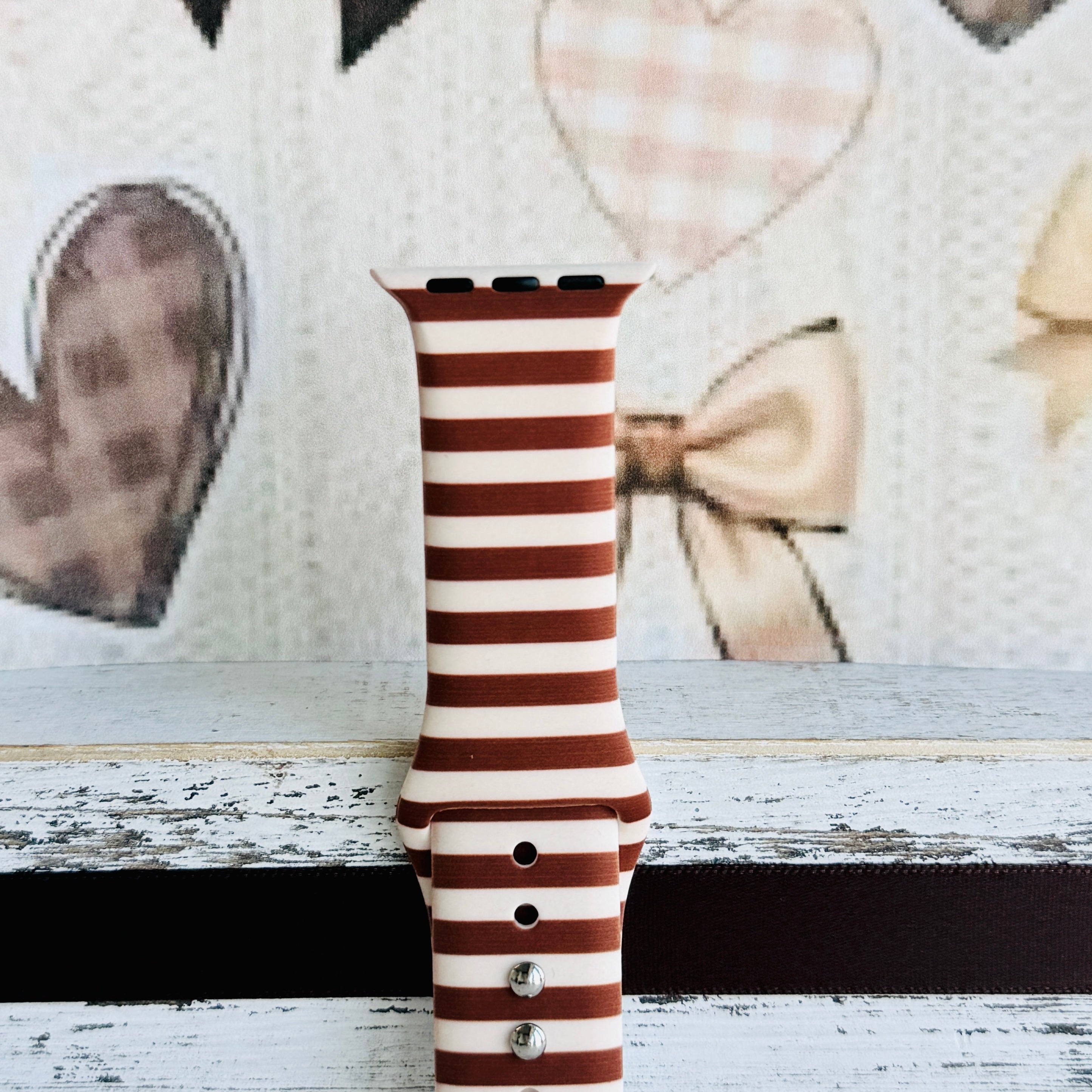 Close-up of the Sweet Espresso Stripes Apple Watch band showing the smooth silicone finish and the even spacing of the brown and cream stripes.