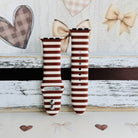Sweet Espresso Stripes Apple Watch band with both strap halves standing on weathered wood, showing the buckle end and the crisp edges of each brown stripe.