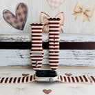 Sweet Espresso Stripes silicone Apple Watch band shown with an Apple Watch, both strap halves standing upright to display the espresso brown and cream horizontal stripes.