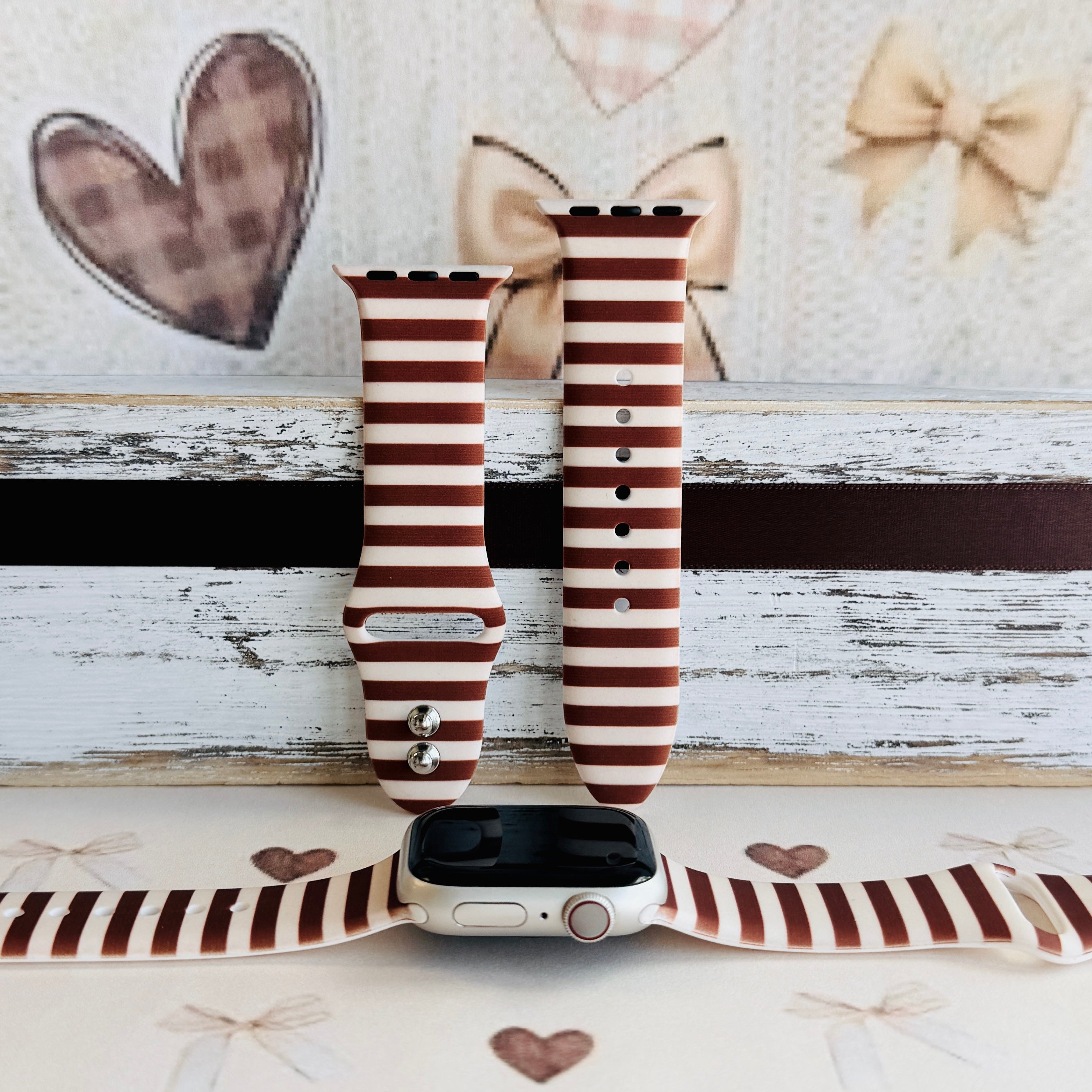Sweet Espresso Stripes silicone Apple Watch band shown with an Apple Watch, both strap halves standing upright to display the espresso brown and cream horizontal stripes.