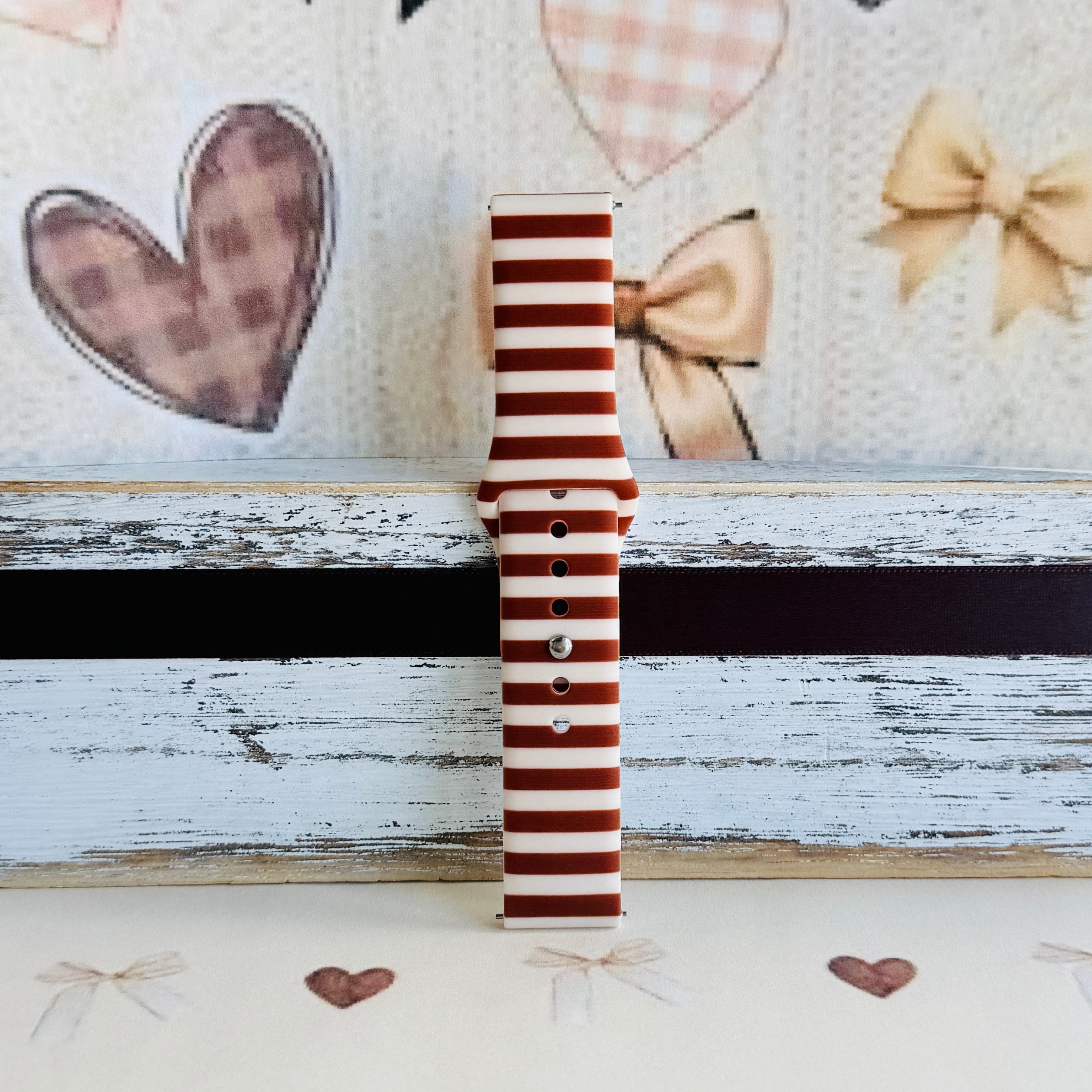 Sweet Espresso Stripes Samsung Galaxy Watch band single strap half standing on weathered wood, showing the espresso and cream stripe print end to end.
