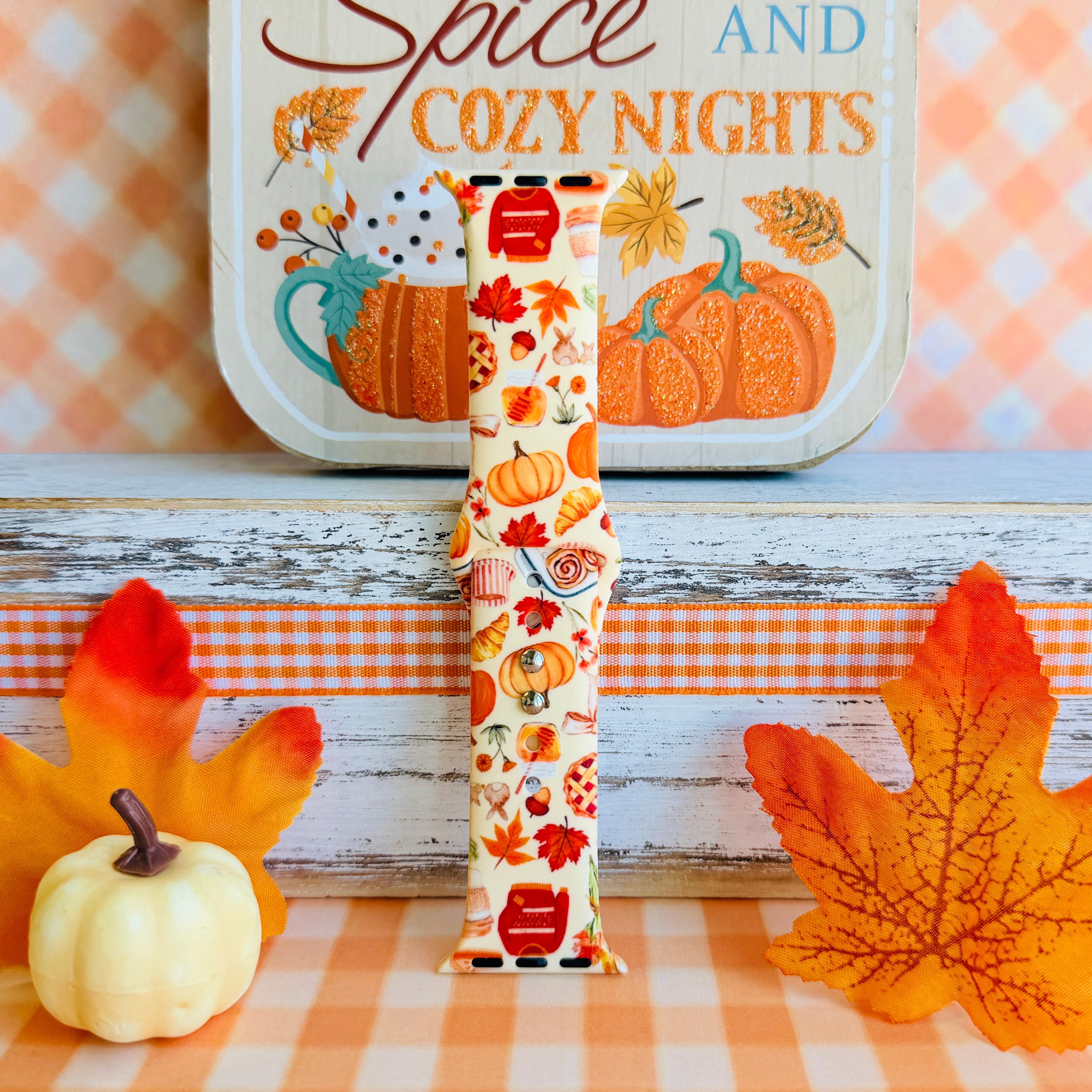 All The Fall Things Apple Watch band single strap half standing upright, showing the cream silicone with pumpkins, pie slices, acorns and turning leaves.