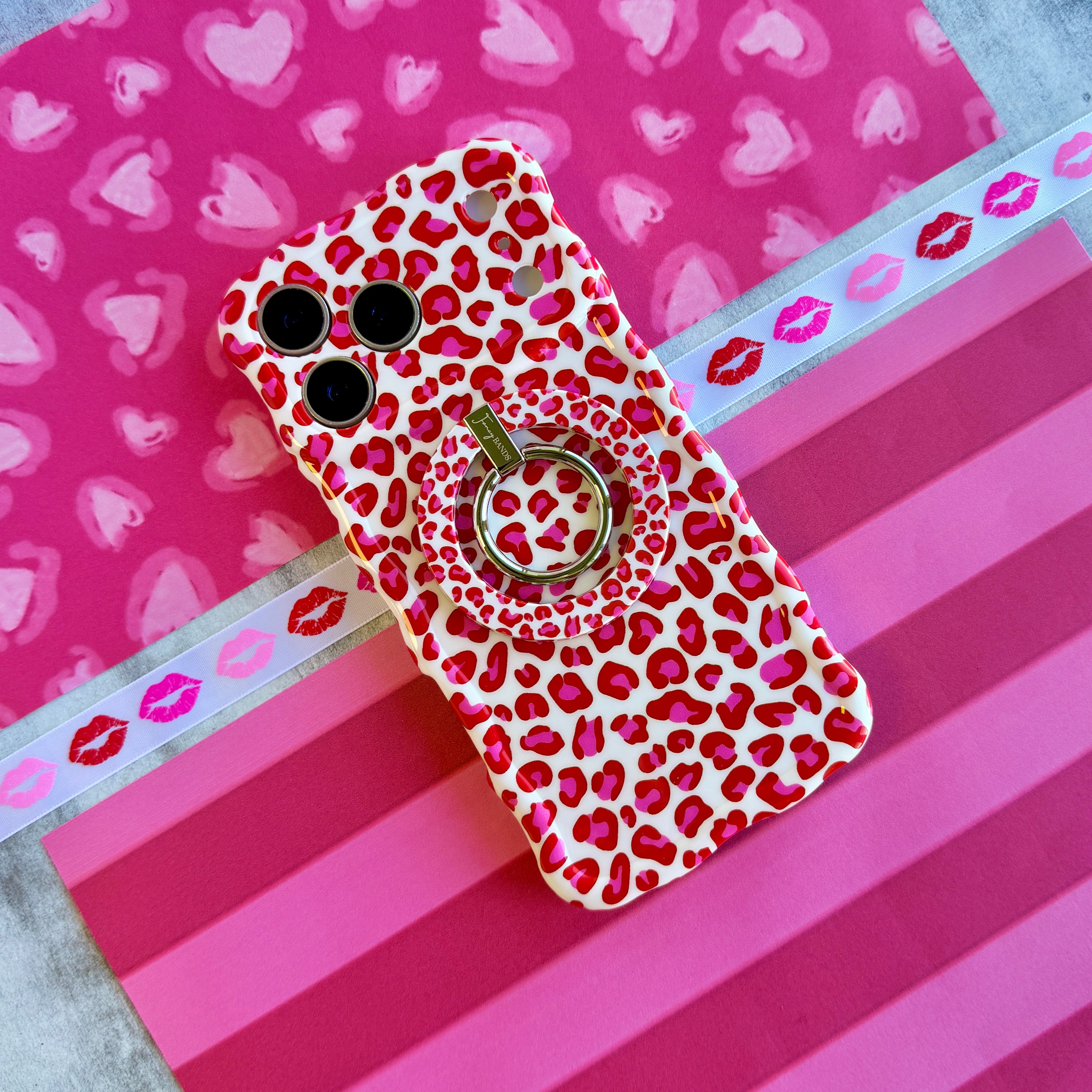 Leopard Crush pattern MagSafe phone grip ring with vibrant pink and red leopard spots on white background compatible with iPhone and Samsung
