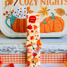 Close-up of the All The Fall Things Samsung Galaxy Watch band showing the watercolor detail on individual pumpkins, coffee cups and cinnamon rolls across the cream strap.