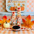 All The Fall Things silicone Samsung Galaxy Watch band shown with a rose gold Galaxy Watch, both strap halves standing upright to display the cream base packed with watercolor pumpkins, pies and autumn leaves.