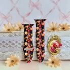 Twilight Bouquet Apple Watch band with vibrant pink, coral, and yellow flowers on black background with white daisies
