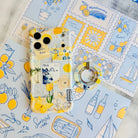 La Dolce Summer Hold It Fancy MagSafe grip ring attached to the matching lemon and blue Mediterranean iPhone case