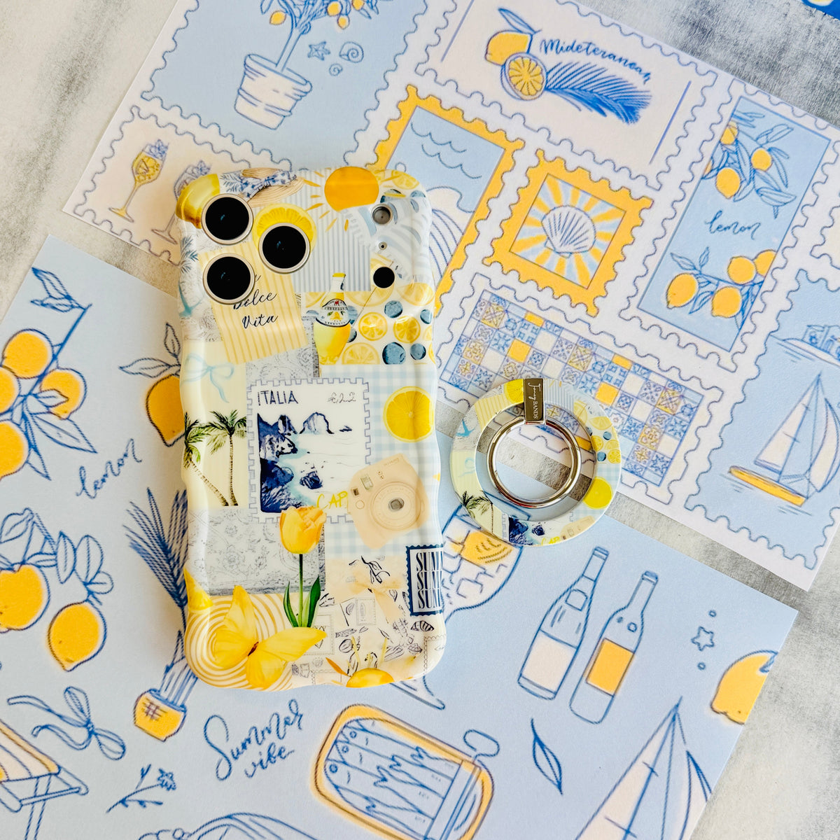 La Dolce Summer Hold It Fancy MagSafe grip ring attached to the matching lemon and blue Mediterranean iPhone case