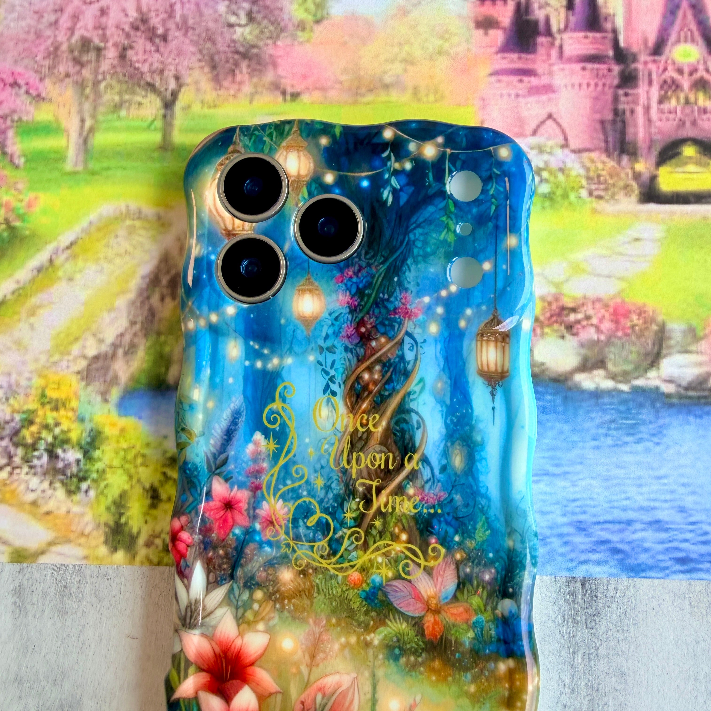 Wavy iPhone case featuring a magical enchanted forest with a twisted tree, glowing lanterns, fairy lights, and gold Once Upon A Time text.