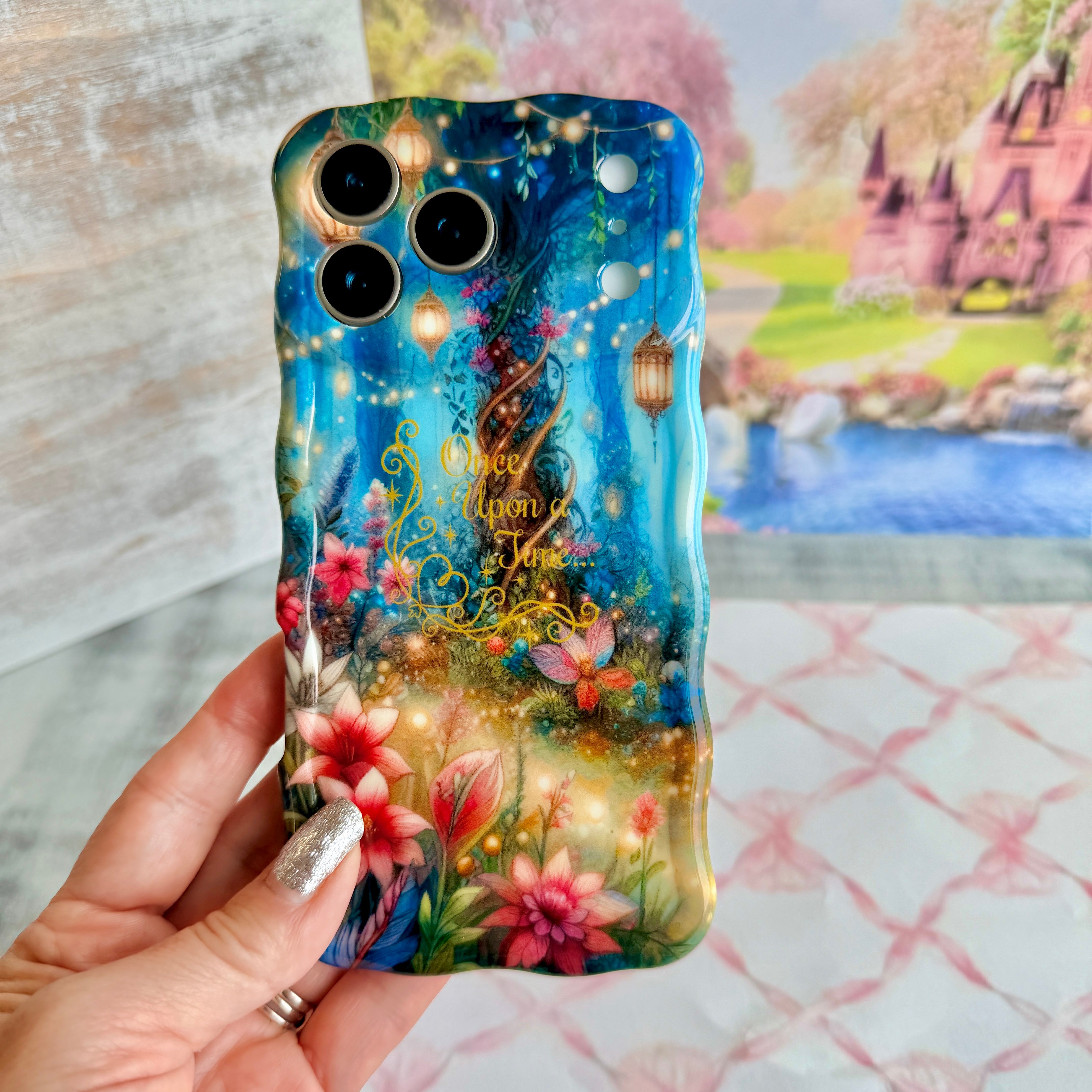 Wavy iPhone case featuring a magical enchanted forest with a twisted tree, glowing lanterns, fairy lights, and gold Once Upon A Time text.