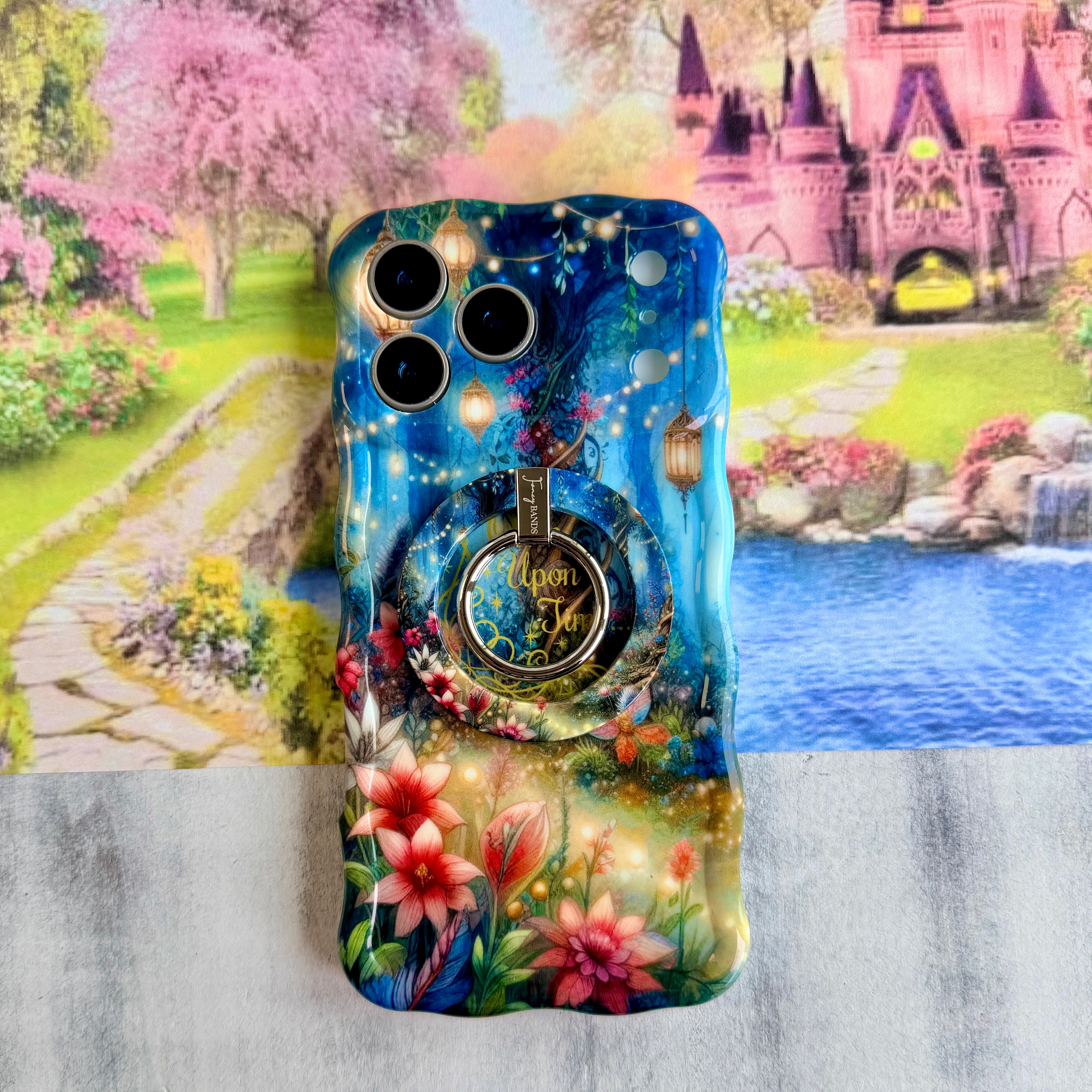 Wavy iPhone case featuring a magical enchanted forest with a twisted tree, glowing lanterns, fairy lights, and gold Once Upon A Time text.