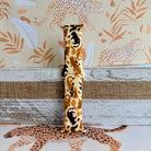 Golden Wildcat Apple Watch band with spotted leopards in golden and brown tones on cream background with safari wallpaper
