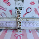 Hair Whisperer Apple Watch band with hairstyling tools, scissors, combs, and roses on white background with #HAIRLIFE backdrop
