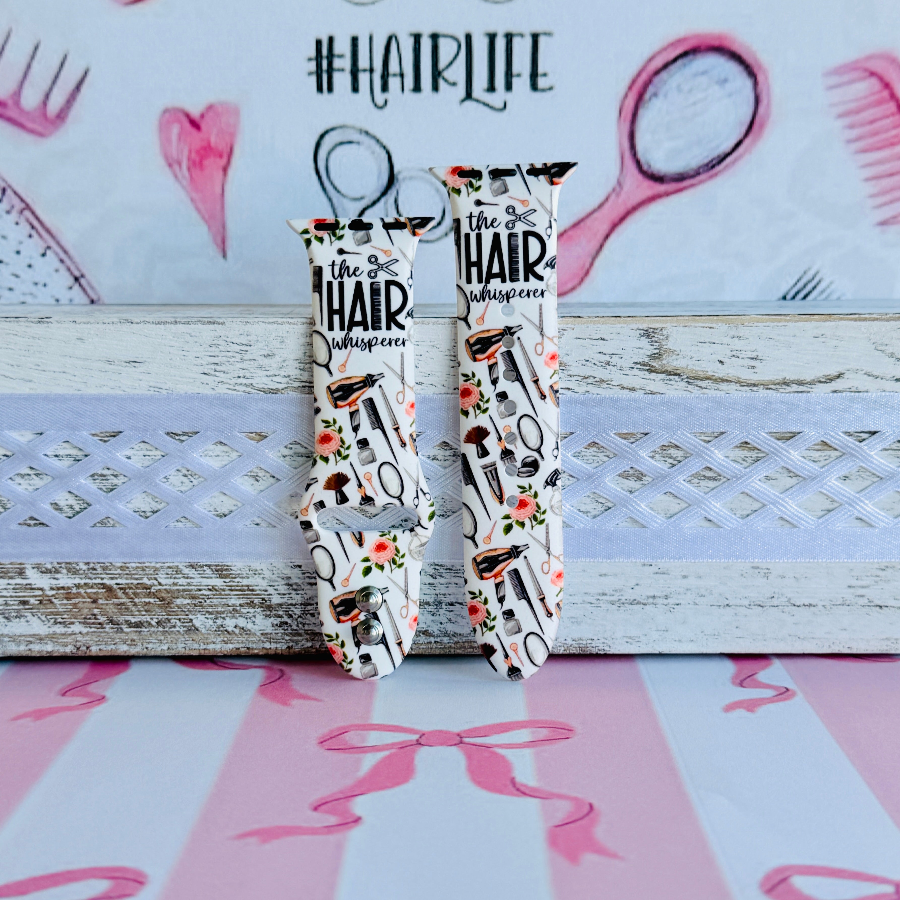 Hair Whisperer Apple Watch band with hairstyling tools, scissors, combs, and roses on white background with #HAIRLIFE backdrop
