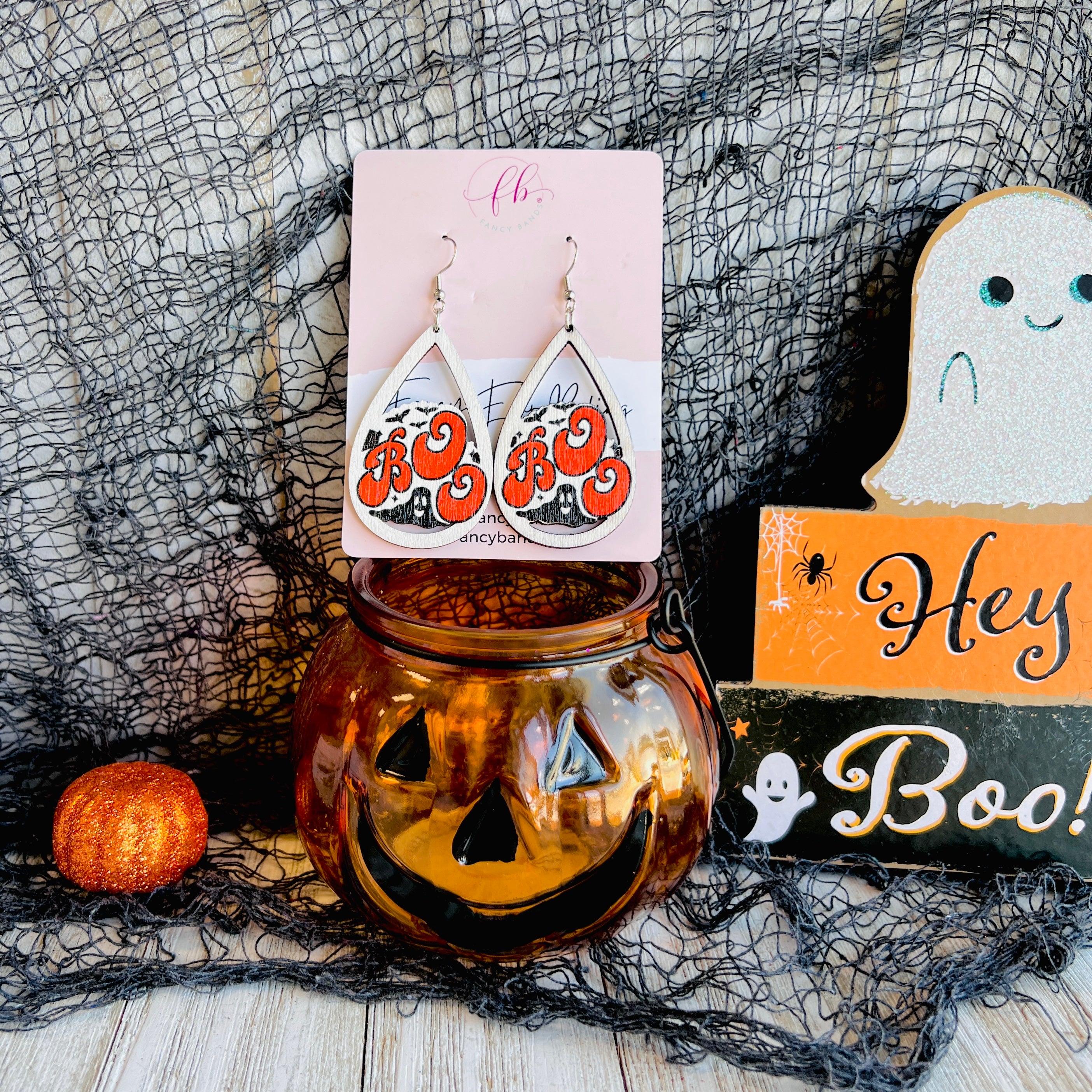 Boo wooden drop earrings styled with pumpkin decor