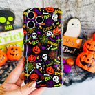 Spooky Wavy Luxe MagSafe iPhone case held in hand, black with orange jack-o-lanterns, white skulls, candy corn and BOO and EEEK! lettering.