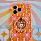 Gossip Girl Retro Edition 70s geometric pattern MagSafe phone grip ring with orange and pink interlocking circles compatible with iPhone and Samsung