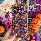 Jack-O-Lantern Jive Wavy Luxe MagSafe iPhone case held in hand, deep violet with glowing orange jack-o-lanterns, lavender ghosts and crescent moons.