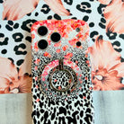 Flower-fetti Leopard pattern MagSafe phone grip ring with pink and orange flowers over black and white leopard spots compatible with iPhone and Samsung