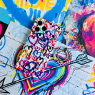 Love Out Loud colorful graffiti heart pattern MagSafe phone grip ring with overlapping neon pink purple and turquoise hearts compatible with iPhone and Samsung
