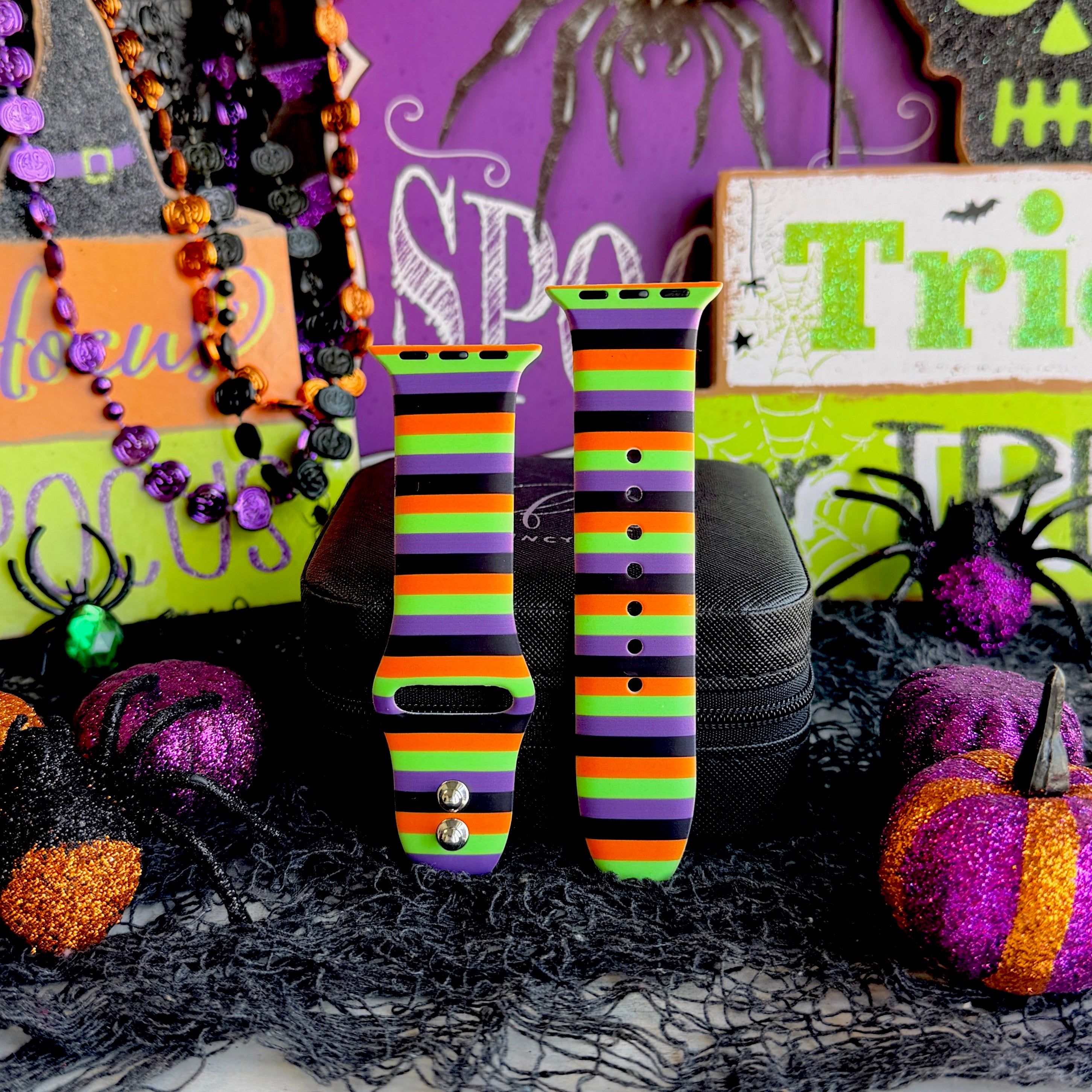 Two Main Witch Energy Apple Watch band straps standing side by side, showing the full horizontal stripe repeat on the silicone.