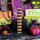 Single Main Witch Energy Samsung Galaxy Watch band strap standing tall beside a green skull sign and glitter pumpkins.