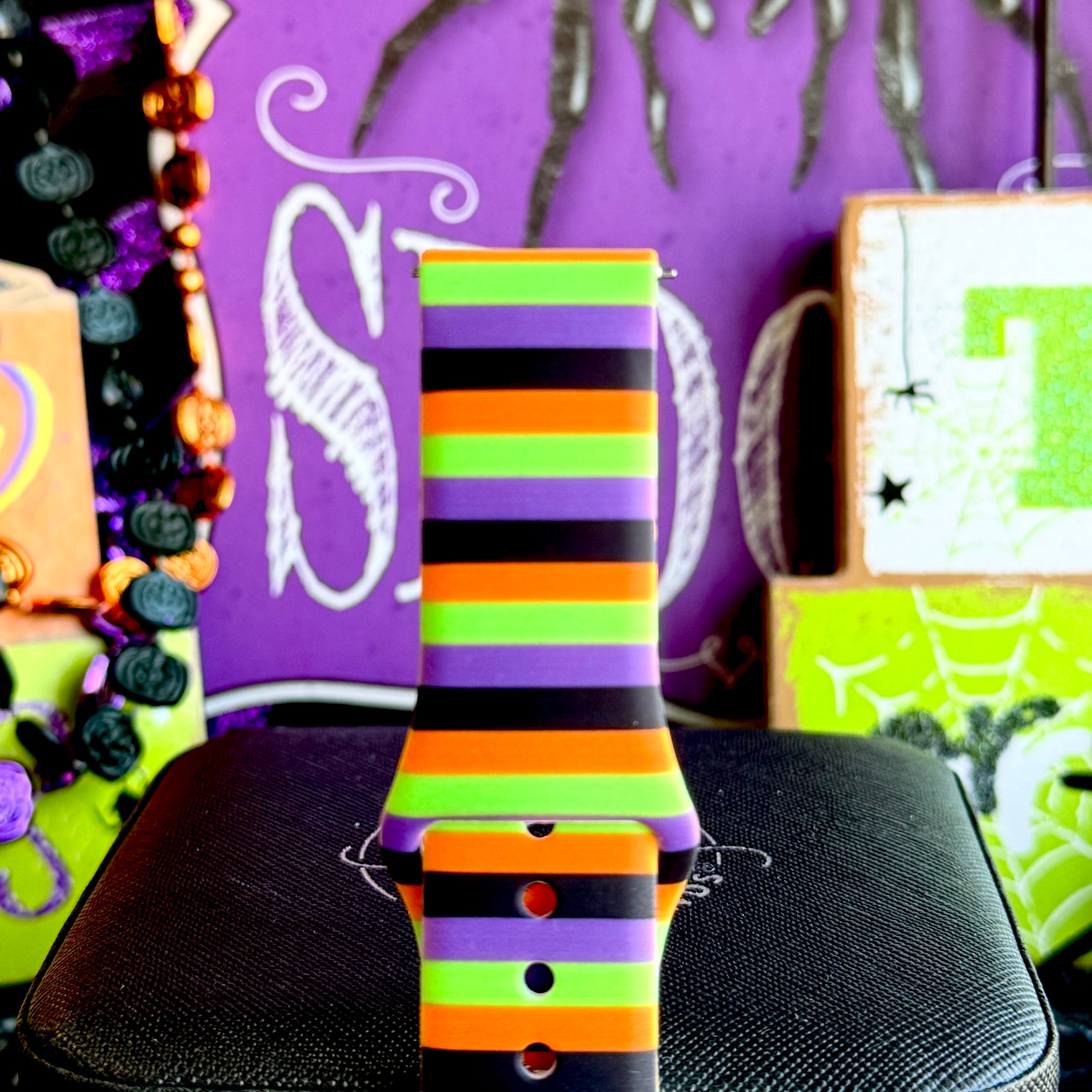 Close-up of the Main Witch Energy Samsung Galaxy Watch band showing the crisp horizontal stripe edges on the silicone strap.