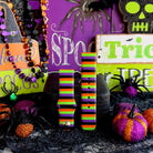 Two Main Witch Energy Samsung Galaxy Watch band straps standing side by side with black spider props and glitter pumpkins.