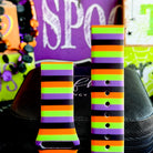 Both halves of the Main Witch Energy Samsung Galaxy Watch band standing upright against a purple SPOOKY sign.