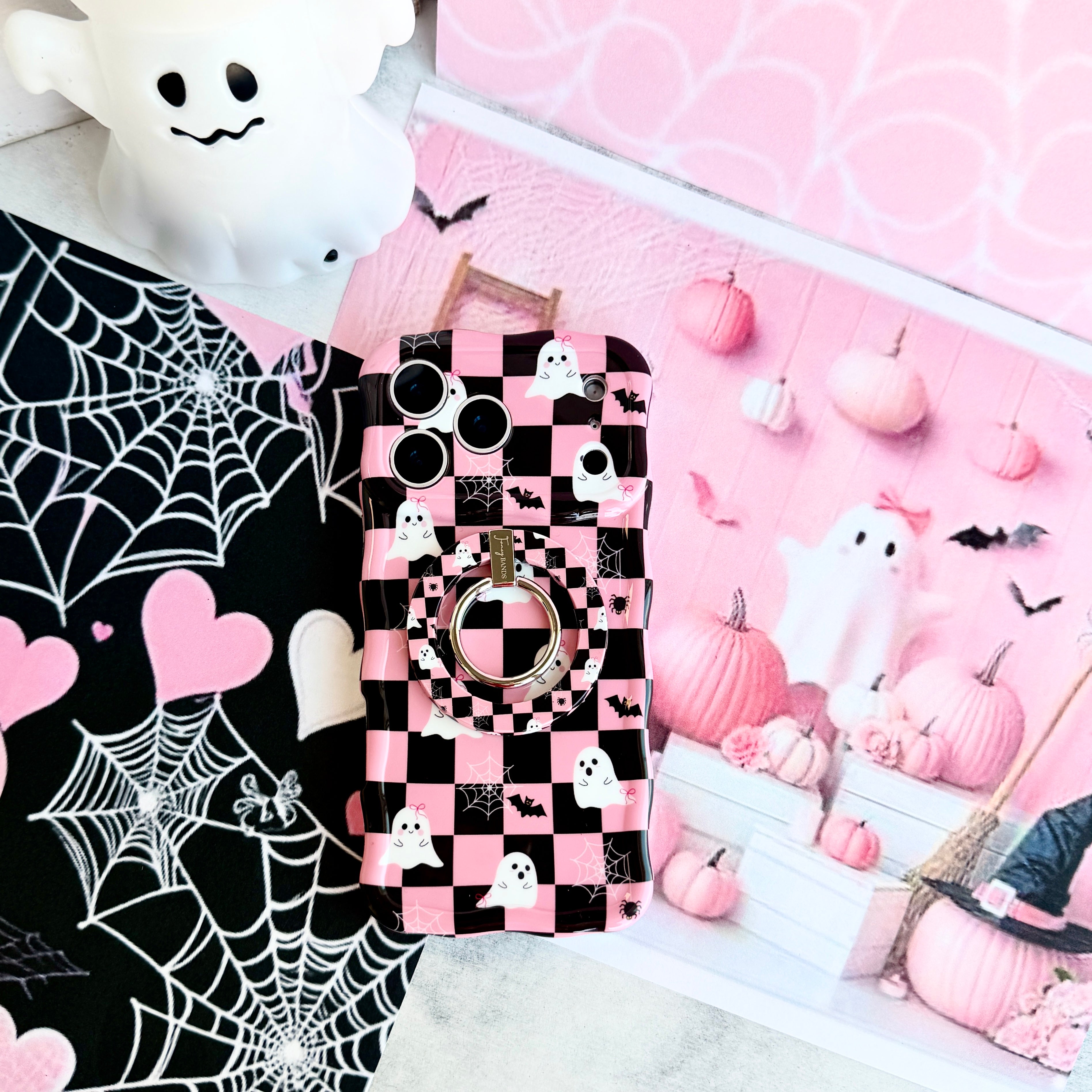 Hey Boo, Looking Cute Hold It Fancy MagSafe grip ring attached to the matching pink checkerboard ghost iPhone case